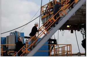  ?? Bloomberg News/Callaghan O’Hare ?? U.S. Vice President Mike Pence (center) climbs the stairs of a horizontal drilling rig during a tour of a Diamondbac­k Energy Inc. oil rig in Midland, Texas in this 2019 file photo.