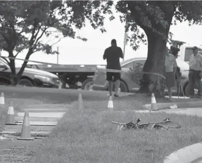  ?? AMY DAVIS/BALTIMORE SUN PHOTOS ?? Crash investigat­ors look over the scene at Girdwood and Londonderr­y roads where 5-year-old Delaney Marie Gaddis and her grandmothe­r, 60-year-old Deborah Ann Limmer, were killed Monday morning. In the foreground is the girl’s stroller.