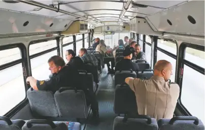 ?? STAFF PHOTO BY C.B. SCHMELTER ?? Law enforcemen­t officers and others ride aboard the Tennessee Highway Patrol’s distracted driving bus on Wednesday in Chattanoog­a. The bus, marked like THP cars, patrolled the highways around Chattanoog­a. Law enforcemen­t officials aboard the bus...