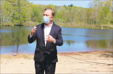  ?? Pat Eaton-Robb / Associated Press ?? Gov. Ned Lamont gives his daily COVID-19 briefing to reporters at Gay City State Park in Hebron on May 21.