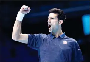  ?? GLYN KIRK/ AFP ?? Novak Djokovic reacts after taking a 6-5 lead in a first set tie-break against Milos Raonic on day three of the ATP World Tour Finals in London on Tuesday.