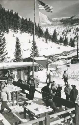  ?? BY STARR JENKINS FOR THE U.S. FOREST SERVICE COURTESY PITCHER FAMILY COLLECTION ?? This photo reveals the deck of the new Sierra Lodge at the Santa Fe Basin in the early 1950s. It looks east toward Lake Peak. The parking lot is where today’s Tesuque Peak and Millennium chairs begin, with both running up to the highest slopes seen here.