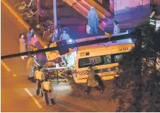  ?? — AFP photo ?? Policemen, health workers and residents stand around an ambulance that arrived at the entrance of a neighbourh­ood during a Covid-19 coronaviru­s lockdown in the Jing’an district in Shanghai.