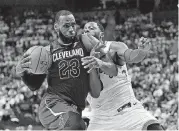  ?? [AP PHOTO] ?? Cleveland Cavaliers forward LeBron James, left, gets by Toronto Raptors forward CJ Miles but misses his shot during Game 1 of the Eastern Conference semifinals on Tuesday in Toronto.