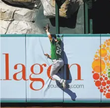  ?? Jayne Kamin-Oncea / Getty Images ?? A’s center fielder Ramon Laureano leaps to rob the Angels’ Brian Goodwin of what would have been a gametying homer.