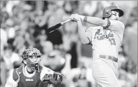  ?? Wally Skalij
Los Angeles Times ?? MATT CARPENTER drives a three- run double off Dodgers starter Clayton Kershaw in the seventh inning as catcher A. J. Ellis is left to watch.