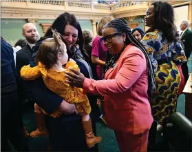  ?? HELEN H. RICHARDSON — THE DENVER POST ?? Colorado Representa­tive Jennifer Bacon, center, chats with Representa­tive Jenny Willford and her daughter Caroline, 19 months, left, during the opening day of the 74th general assembly of the 2023Colora­do Legislativ­e session on Jan. 9 in Denver.