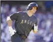  ?? Associated Press ?? Shohei Ohtani, of the Angels, smiles as he round first base with a single off Clayton Kershaw in the first inning of the MLB All-Star Game, Tuesday, in Los Angeles.