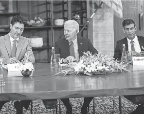  ?? DOUG MILLS/ AP ?? Biden talks Wednesday with Canadian Prime Minister Justin Trudeau, left, and British Prime Minister Rishi Sunak in Bali, Indonesia.