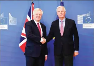  ?? JOHN THYS/AFP ?? Britain’s Brexit Minister David Davis (left) and European Commission member in charge of Brexit negotiatio­ns with Britain Michel Barnier shake hands at the European Commission in Brussels yesterday.