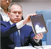  ?? AFP-Yonhap ?? Israeli Ambassador to the U.N. Gilad Erdan shows a video of drones and missiles heading toward Israel during a United Nations Security Council meeting at U.N. headquarte­rs in New York City, Sunday.