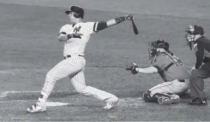  ?? Mike Stobe, Getty Images ?? Gary Sanchez of the New York Yankees hits a solo home run during the seventh inning Wednesday against the Houston Astros in Game 5 of the American League Championsh­ip Series at Yankee Stadium.