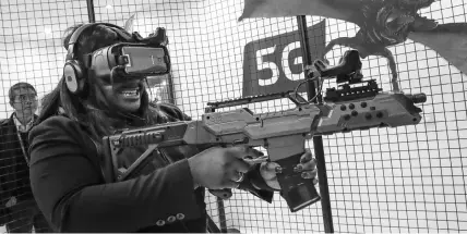  ??  ?? A person tries out virtual reality game on 5G technology at the Mobile World Congress in Spain