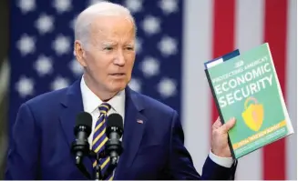  ?? ?? President Joe Biden holds a copy of the Republican Study Committee’s FY2024 budget proposal as he speaks about his administra­tion’s economic agenda during an event in Maryland in 2023.