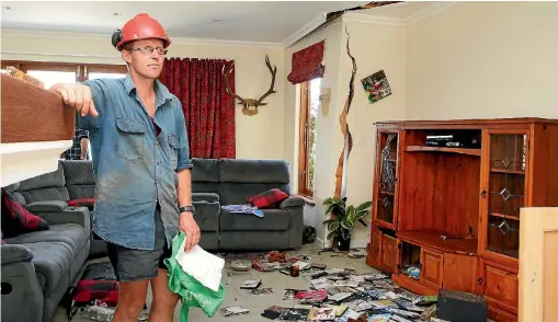  ?? PHOTO: DEREK FLYNN/FAIRFAX NZ ?? Kekerengu Road farmer Duncan Furniss inspects the damage to his dream home, which was condemned after the earthquake.