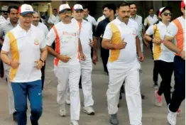  ?? — PTI ?? Minister of state for home Kiren Rijiju (left) participat­es in the BSF half marathon at Jawaharlal Nehru Stadium in New Delhi on Sunday.