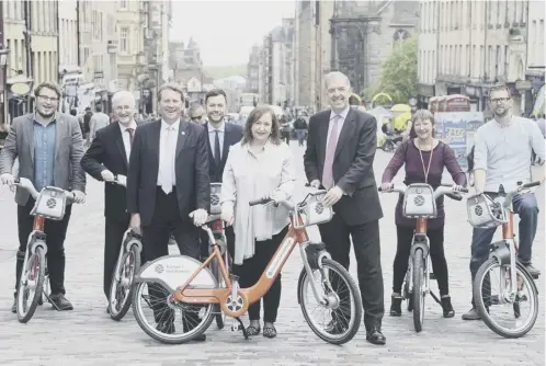  ??  ?? Edinburgh councillor­s and cycling organisati­ons with Serco officials yesterday as the new cyle scheme was announced