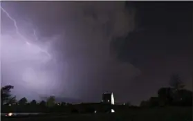  ?? ALBERT CESARE — THE MONTGOMERY ADVERTISER VIA AP ?? Lightning runs through cloud over Blount Cultural Park in Montgomery, Ala., Wednesday as a thundersto­rm moves through southern Montgomery County. A powerful tornado toppled trees and downed power lines in rural Georgia and similar scenes played out in...