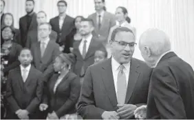  ??  ?? Meyerhoff Scholars line up on stage for a photograph as UMBC President Freeman A. Hrabowski III, facing camera in foreground, chats with Robert E. Meyerhoff.