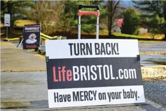  ?? AP PHOTO/EARL NEIKIRK ?? Anti-abortion signs line the sidewalk Feb. 23 outside Bristol Women’s Health Clinic in Bristol, Va.