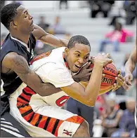  ?? Arkansas Democrat-Gazette/THOMAS METTHE ?? Little Rock Hall’s Xzavier Madison (right) fights for a rebound with Little Rock Fair’s Mickael Foust during the first half of the Warriors’ 50-39 victory Thursday at Hall High School in Little Rock.