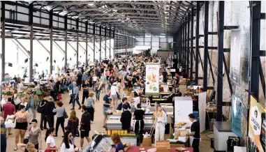  ??  ?? BARGAIN HUNT: Crowds enjoying a day at Carriagewo­rks Farmers Markets in Eveleigh