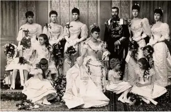  ??  ?? George V and Queen Mary on their wedding day with their bridesmaid­s in 1893