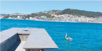  ??  ?? A man climbed to the top of Len Lye’s WaterWhirl­er in Wellington (above) before it broke and sent him hurtling into the water (left).