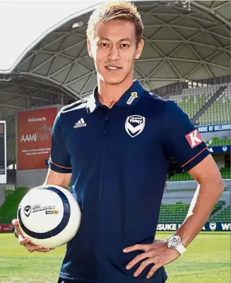  ?? — AFP ?? Busy, busy man: Japanese player Keisuke Honda posing for a photo after signing to play with Melbourne Victory in Australia’s A-League yesterday.