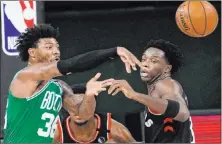  ?? Mark J. Terrill The Associated Press ?? Celtics guard Marcus Smart passes the ball in front of Raptors forward OG Anunoby in the first half of Toronto’s 104-103 win Thursday at the Wide World of Sports Complex.