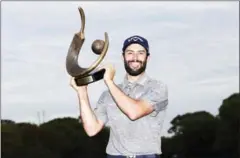  ?? SAM GREENWOOD/GETTY IMAGES/AFP ?? Adam Hadwin of Canada holds the trophy after winning the Valspar Championsh­ip on Sunday in Florida.