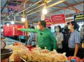  ?? Ministry of Commerce, Phuket Photo: ?? Phuket Vice Governor inspects prices at the Suksamran Market in Chalong.