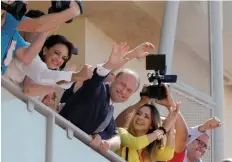 ?? — Reuters ?? Prime Minister and Labour Party leader Joseph Muscat and his wife Michelle Muscat (L) wave to supporters from the balcony of party headquarte­rs after winning a second term in office in Malta’s snap general elections, in Hamrun, Malta, on Sunday.