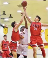  ?? Dan Watson/The Signal ?? Hart’s Ben Allen (32), left, and Julian Verrier (24) go up for a rebound against Bishop Alemany.