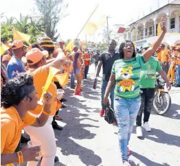  ?? IAN ALLEN/PHOTOGRAPH­ER ?? Jamaica Labour Party supporters walk through Kellits on nomination day, as People’s National Party stand on the roadside. Gordon Robinson writes: During this silly season, one political sheep lost a leg and another, being groomed for a life of automatic adulation, died in political motorcades promoting lawless, irresponsi­ble behaviour as partisan political policy.