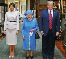  ??  ?? Visit: US president Trump with the Queen and his wife Melania in the Grand Corridor at Windsor Castle