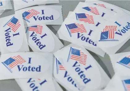  ?? MARK BLACK/BEACON-NEWS ?? A pile of “I Voted” stickers were available to voters at the Vaughan Athletic Center in Aurora, Illinois, on Nov. 8.