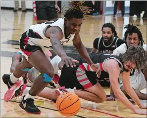  ?? DANA JENSEN/THE DAY ?? After Mitchell and Eastern Nazarene players scrambled after the loose ball Mitchell’s Wilton Causey (30) moves in to take control during Saturday’s game in New London.