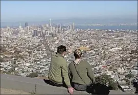  ?? Luis Sinco Los Angeles Times ?? A COUPLE view the San Francisco skyline in August. The city’s health department said it isn’t using a “criminal justice approach for a public health challenge.”