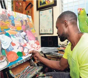  ??  ?? Artist Lennox Coke at work in his Kingston studio.