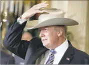  ?? ALEX BRANDON — THE ASSOCIATED PRESS ?? President Donald Trump tries on a Stetson hat, from Garland, Texas, during a “Made in America” showcase featuring items created in each of the U.S. 50states on Monday.