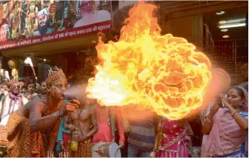  ?? — AFP ?? A dancer performs a fire act during a procession to mark the 661st anniversar­y of the birth of Bawa Lal Dayal Maharaj in Amritsar on Tuesday. Bawa Lal Dayal Maharaj is especially revered by devotees of a temple in the town of Dhyanpur, some 45 km north...