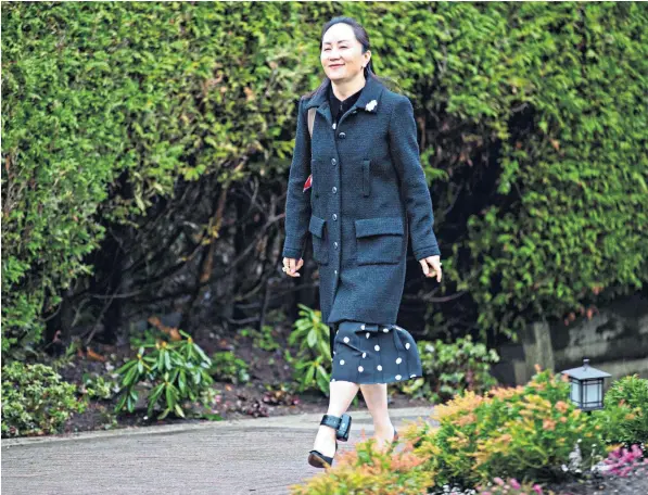  ??  ?? Meng Wanzhou, daughter of Huawei’s founder, leaves her home in the run-up to her extraditio­n hearing. She wears an ankle bracelet, has an 11pm curfew and is tracked around the clock to ensure she does not leave Canada