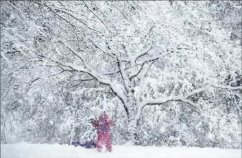  ?? Matt Slocum/Associated Press ?? A girl plays in the snow during a storm Wednesday in Marple Township outside of Philadelph­ia.