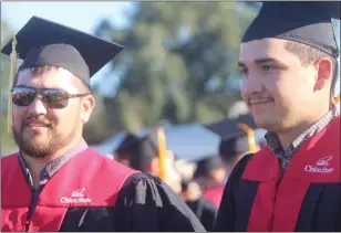  ?? ?? Ryan Johnson, and Julio Vasquez wait in line before they graduated from the College of agricultur­e at California State University, Chico, on Friday.