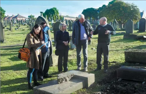  ?? ZHANG RONG / FOR CHINA DAILY ?? Members of an inspection team from the China Foundation for Cultural Heritage Conservati­on discuss restoratio­n plans with a memorial stonemason and local councillor­s in Newcastle-upon-Tyne, England.