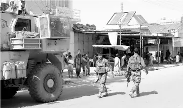  ??  ?? Afghan National Army soldiers keep watch during an official visit in Farah province, Afghanista­n.