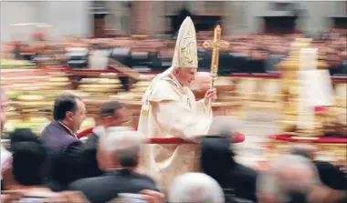  ?? Photo: REUTERS ?? Peace plea: Pope Benedict XVI leaves at the end of the Christmas night mass in St Peter’s Basilica in the Vatican.