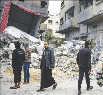  ?? AP PHOTO/FATIMA SHBAIR ?? Palestinia­ns inspect a house after it was hit by an Israeli bombardmen­t on Rafah, southern Gaza Strip on Thursday.