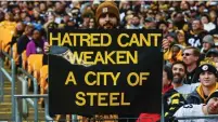  ?? (Jeffrey Becker/USA Today Sports) ?? A FAN at Pittsburgh’s Heinz Field honors the victims of the massacre at the Tree of Life synagogue, in October.